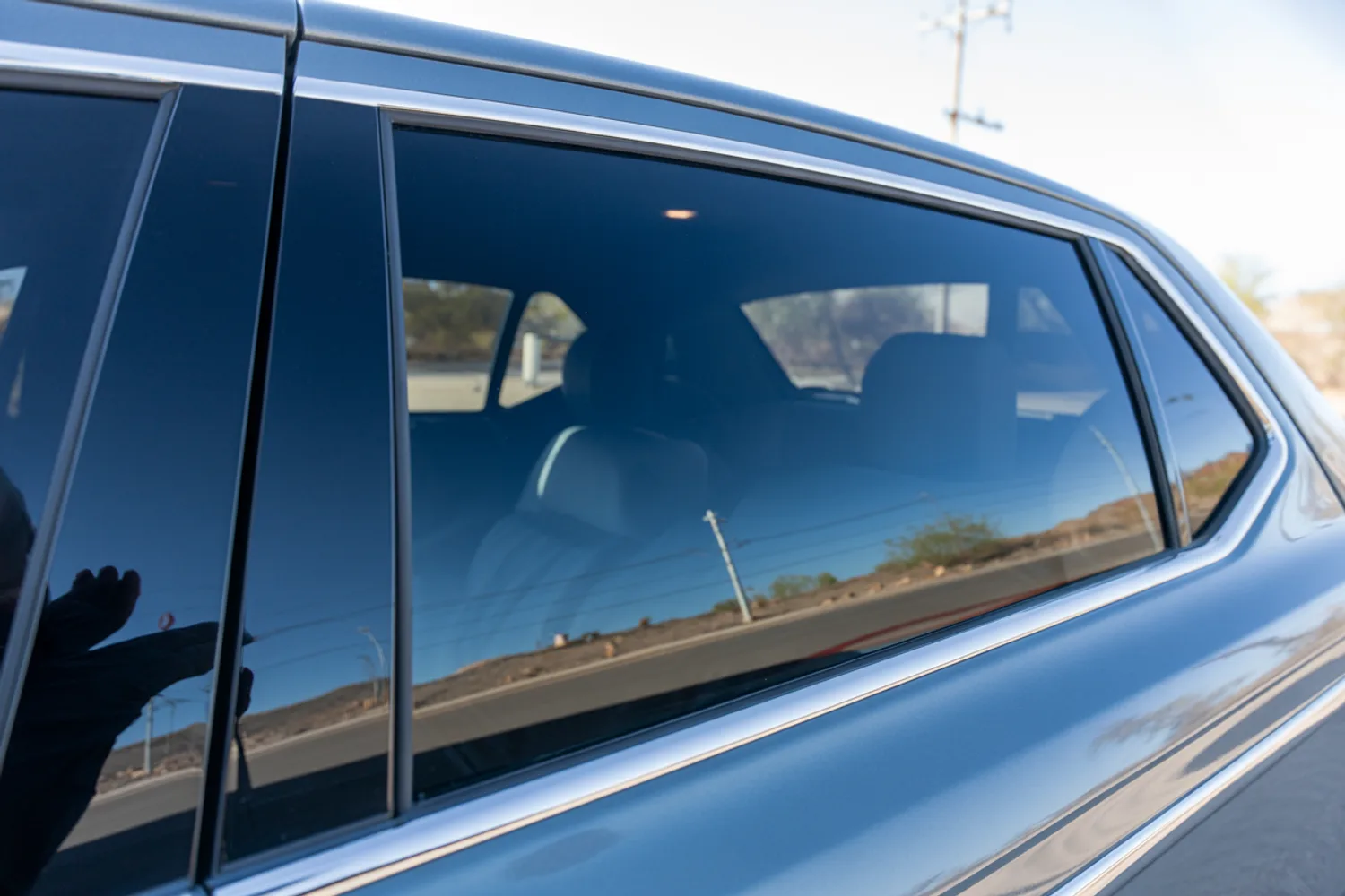 Evenly tinted car side windows reflecting an Arizona desert street